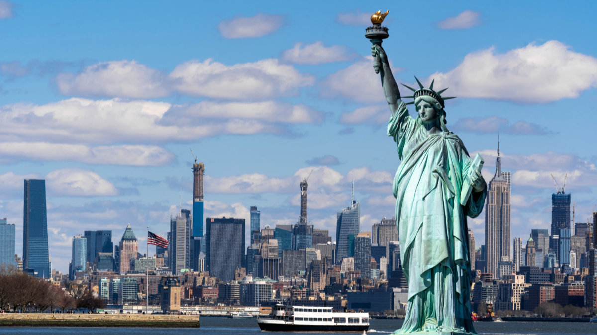 the statue of liberty over the scene of new york cityscape river